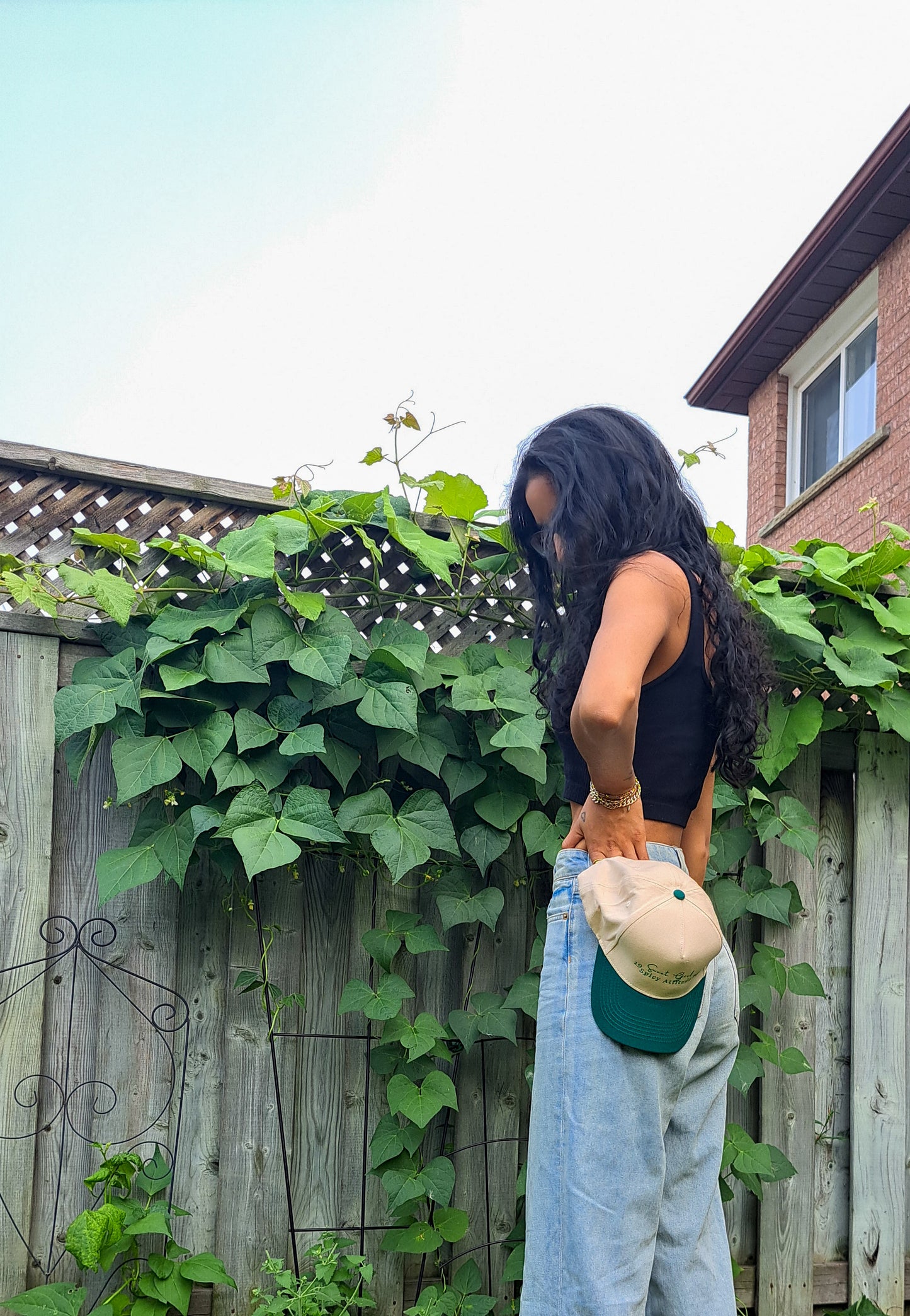woman gardening in Trucker green and ivory hat