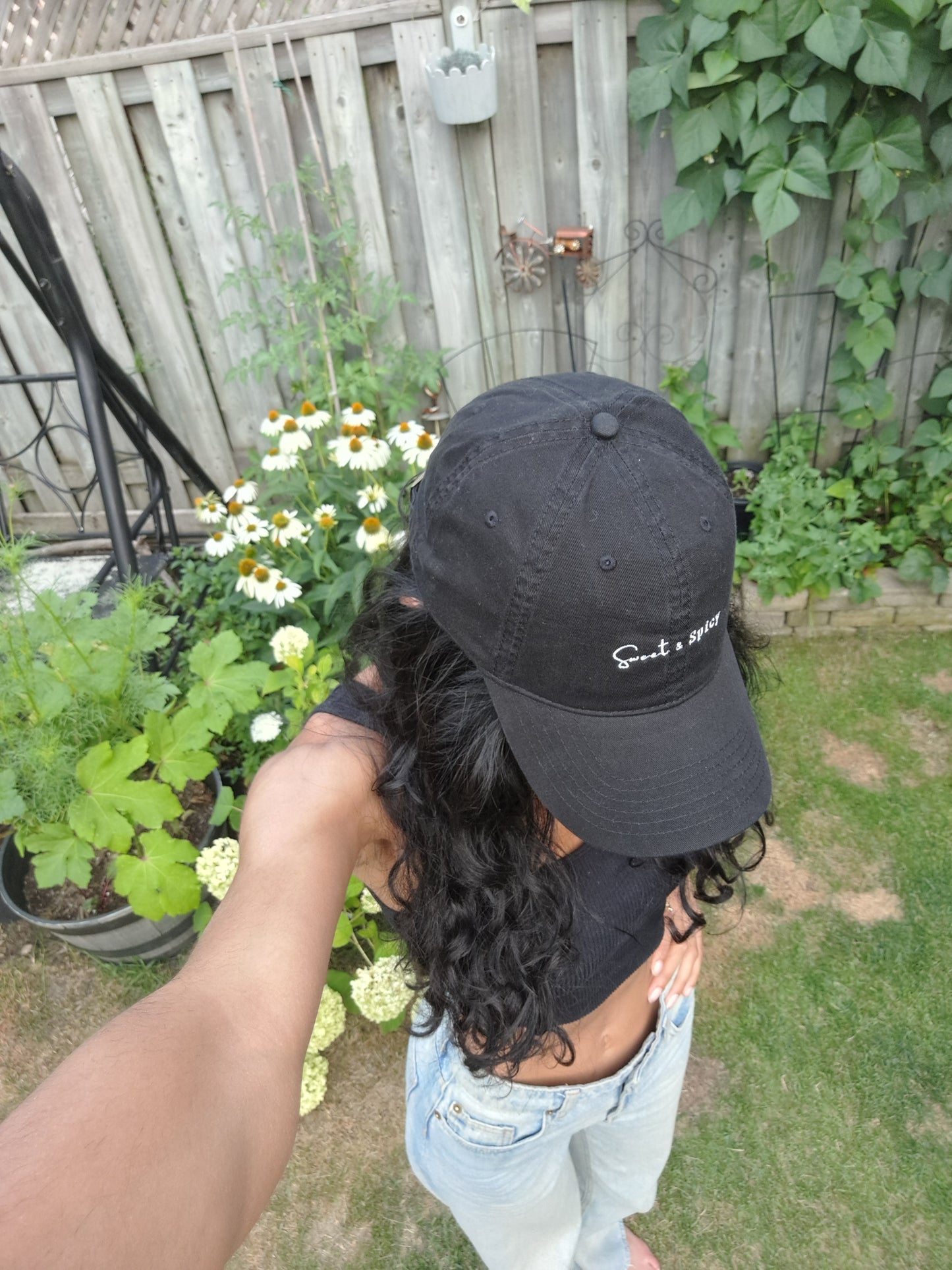 woman gardening in Black and white logo hat