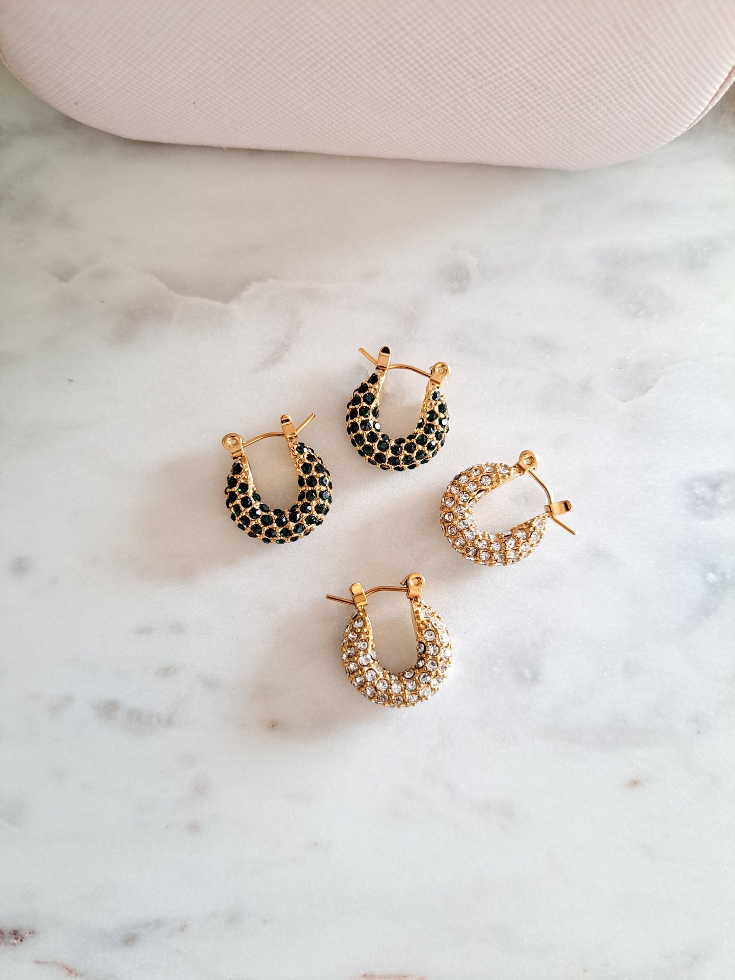 gold and diamond hugging earrings and emerald green huggie earrings