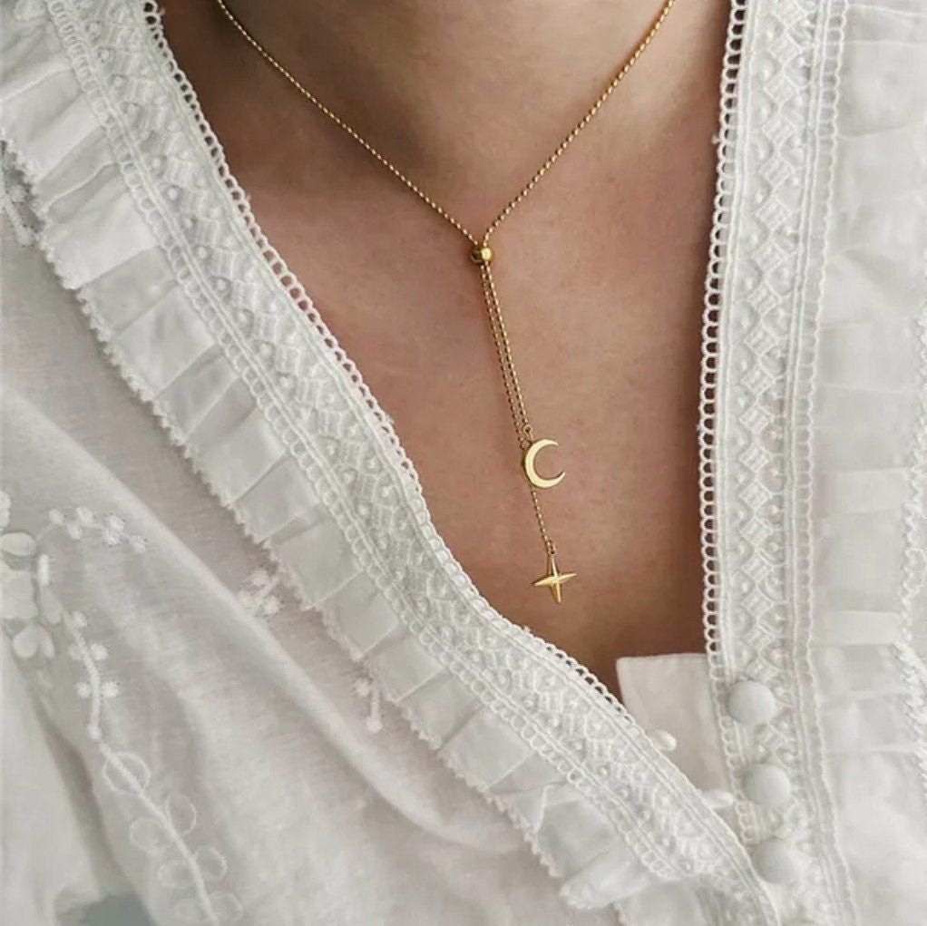 woman wearing moon star necklace