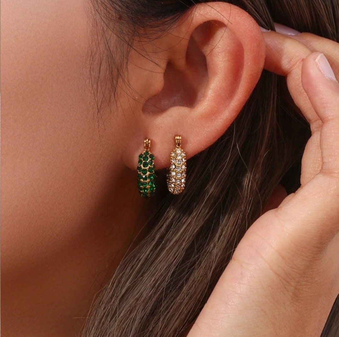 woman wearing huggie earring stack