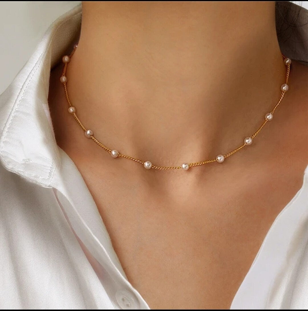 woman wearing a dainty pearl necklace