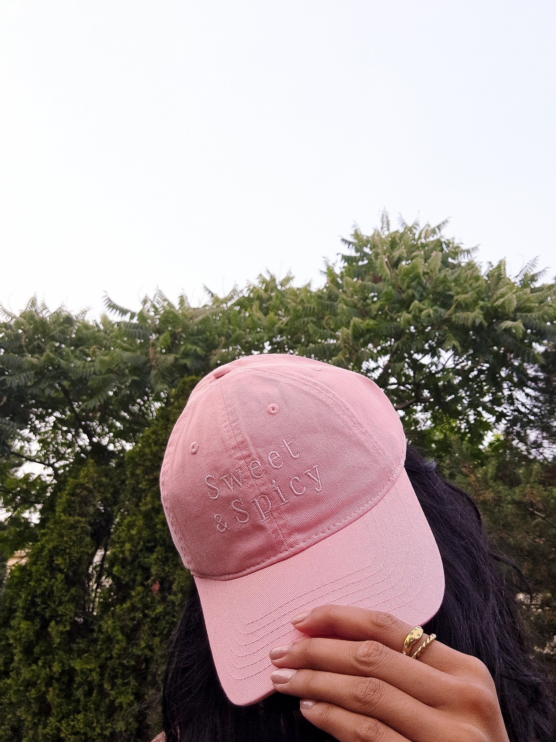 Pink cap on girl in the backyard gardening 