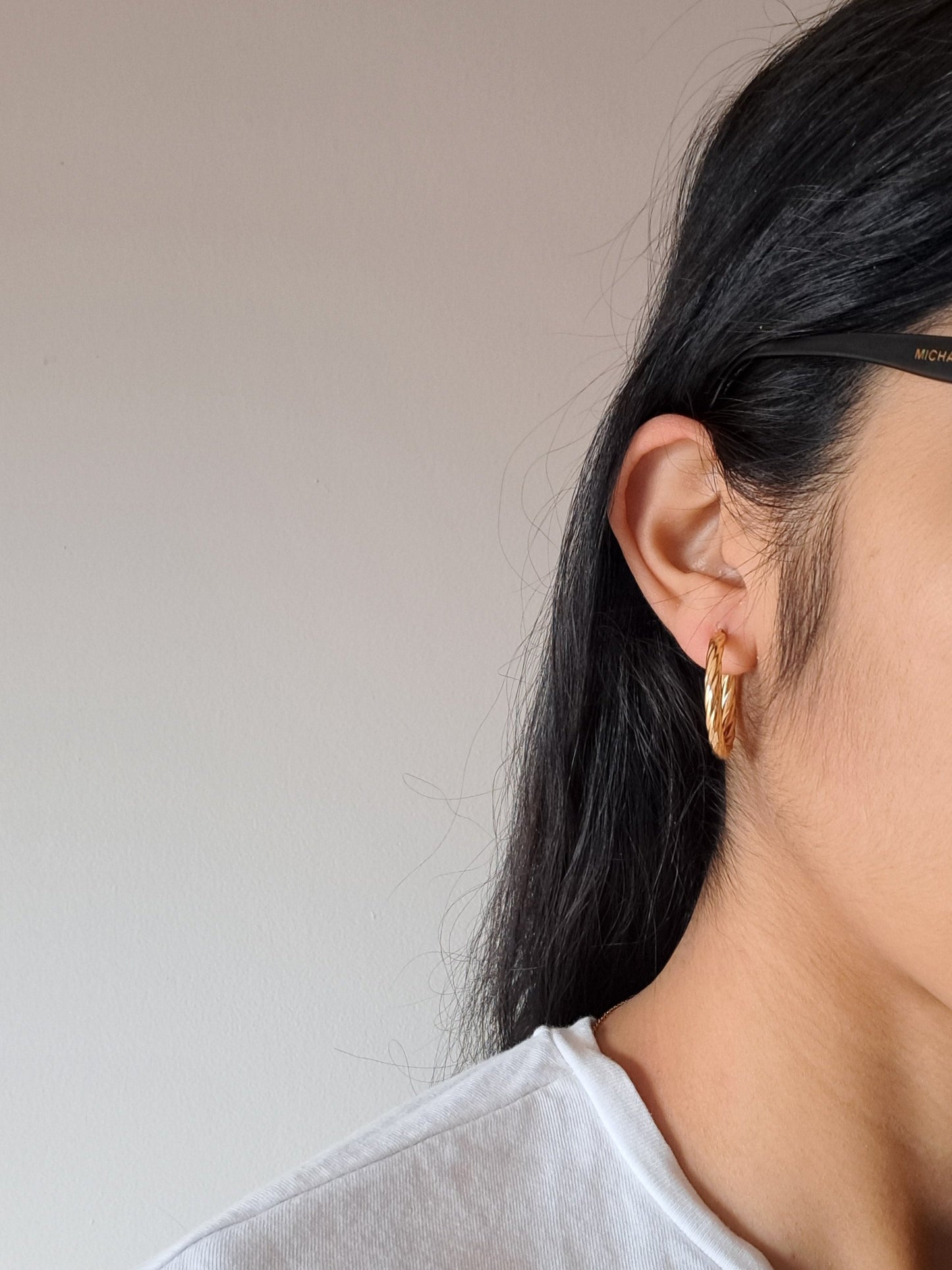 Woman wearing gold hoop earrings 