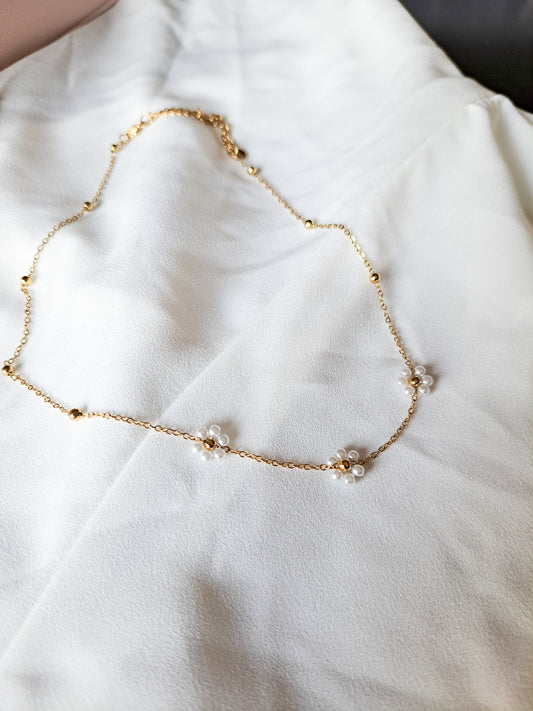 gold beaded chain necklace with pearl flowers throughout 