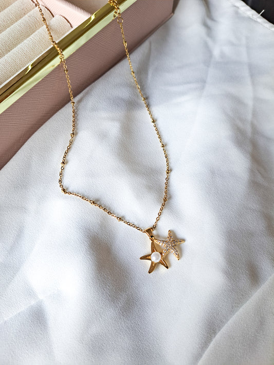 18k gold plated beaded necklace with a gold sea shell with a pearl and a diamond sea shell 