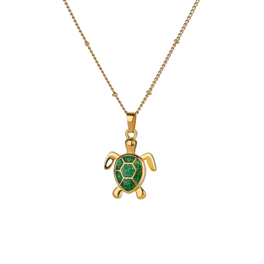 Green turtle pendant necklace on gold chain
