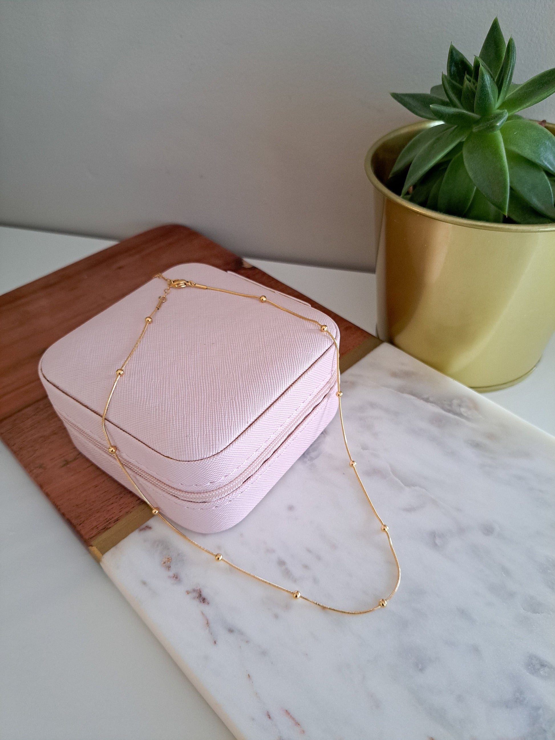 Beaded gold chain necklace with delicate detailing

